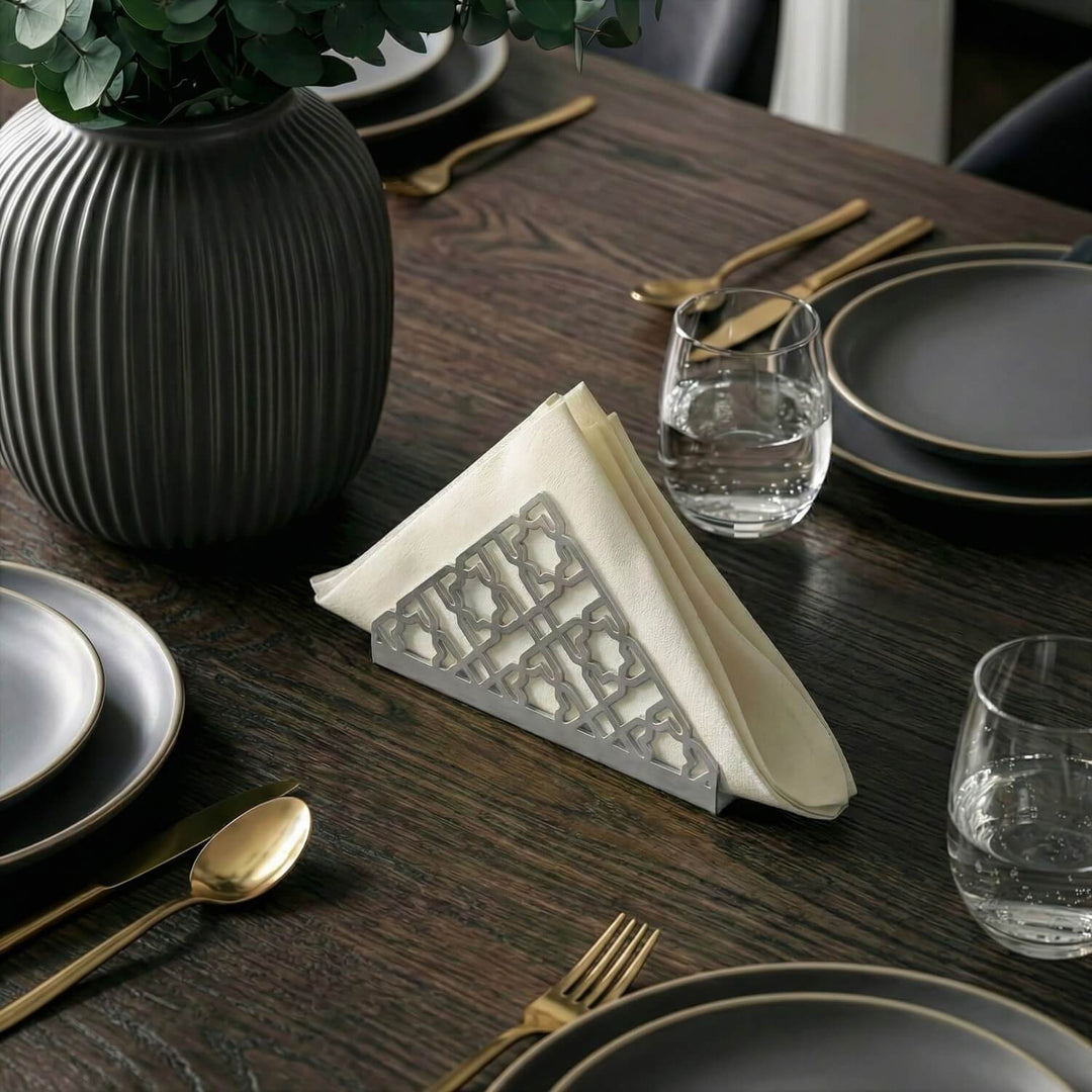 Geometric metal napkin holder in silver on a set table