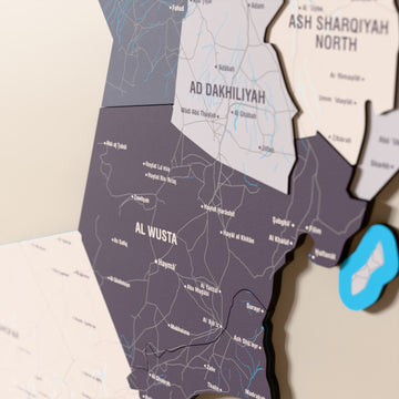 Close-up of the Nimbus Oman wooden wall map with layered regions and printed names