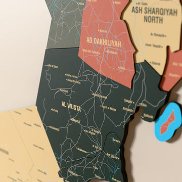 Close-up of the Sage Oman wooden wall map with layered regions and printed names