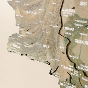 Close-up of the Satellite Pakistan wooden wall map with layered regions and printed names