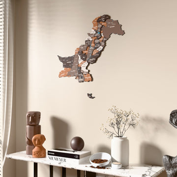 Soil Pakistan wooden wall map beside a sheer curtain, angled view