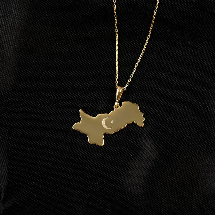 Pakistan map necklace in gold on black satin