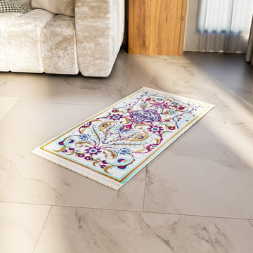 Pastel floral and aqua prayer rug on a marble floor in front of a cream sofa