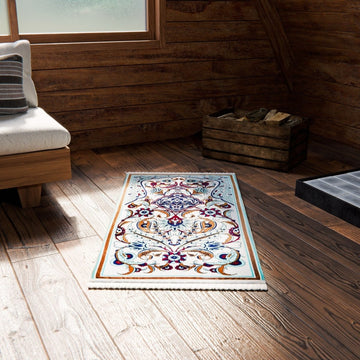 Pastel floral and aqua prayer rug on a wooden cabin floor by a window