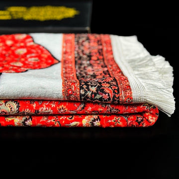 Folded red and white fringed prayer rug from the Ramadan gift set, close-up of the pattern
