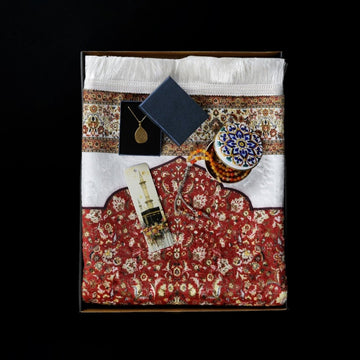 Packed Ramadan gift set with red prayer rug, pendant box, bookmark and amber beads tin, top view
