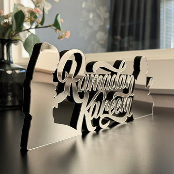 Silver Ramadan Kareem lettering on the prayers detail tabletop decor, close angled view