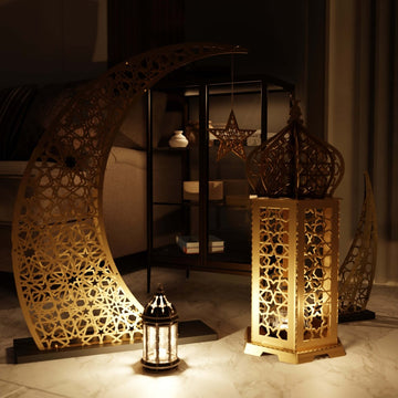 Gold Ramadan lantern beside a large gold crescent moon decoration in a warmly lit living room
