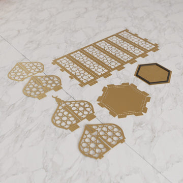 Flat gold lantern parts laid out on white marble before bending and assembly