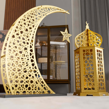 Gold Ramadan lantern with hanging star next to a tall laser-cut gold crescent, close view