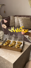 Gold Ramadan Mubarak sign on a tray of pastries in a living room