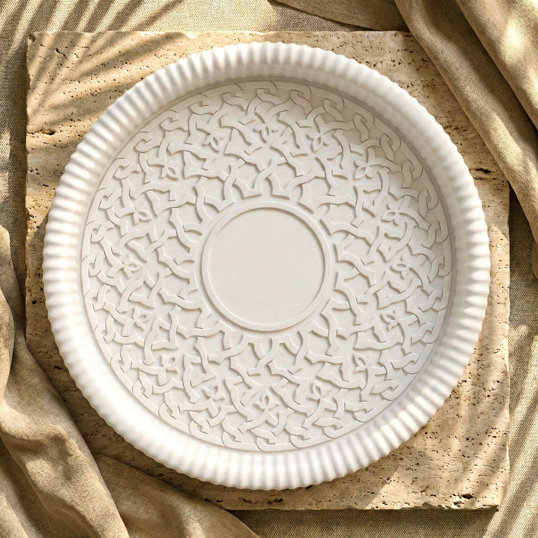 Top view of round white ceramic Islamic geometric tray used as elegant tabletop decor