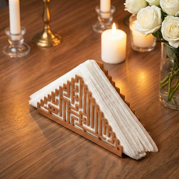 Bismillah Kufic metal napkin holder in copper on a set table