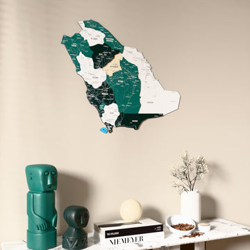 Flag colored Saudi Arabia wooden wall map on a beige wall above a console with figurines