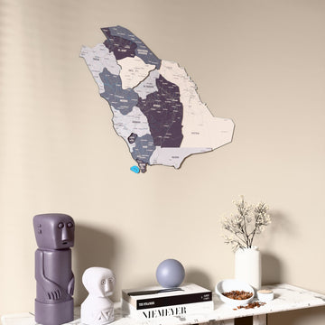 Nimbus Saudi Arabia wooden wall map on a beige wall above a console with figurines