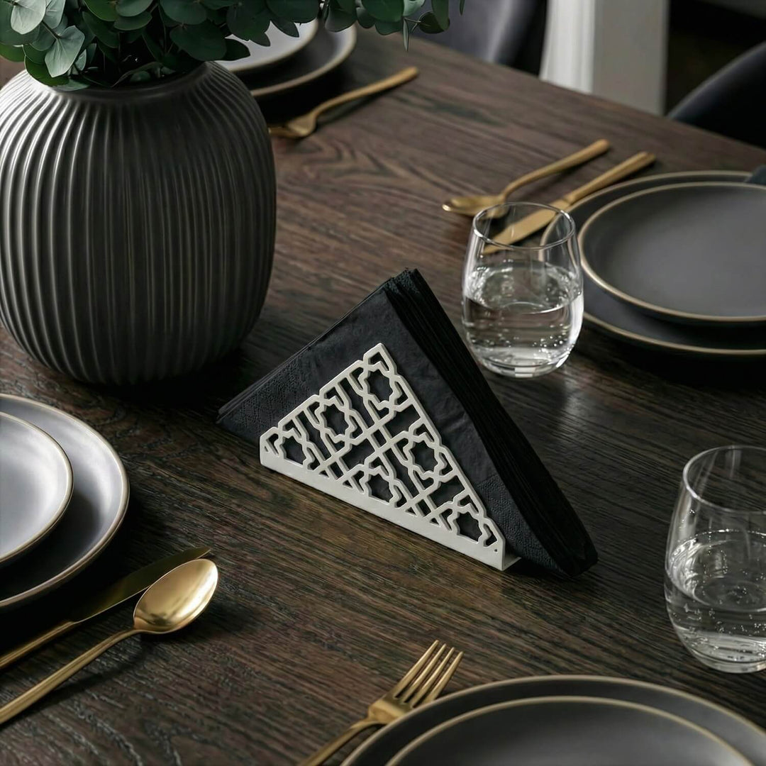 Geometric metal napkin holder in white on a set table