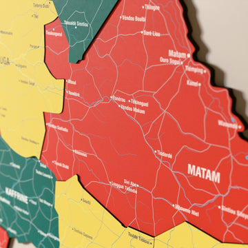 Close-up of the Flag colored Senegal wooden wall map with layered regions and printed names