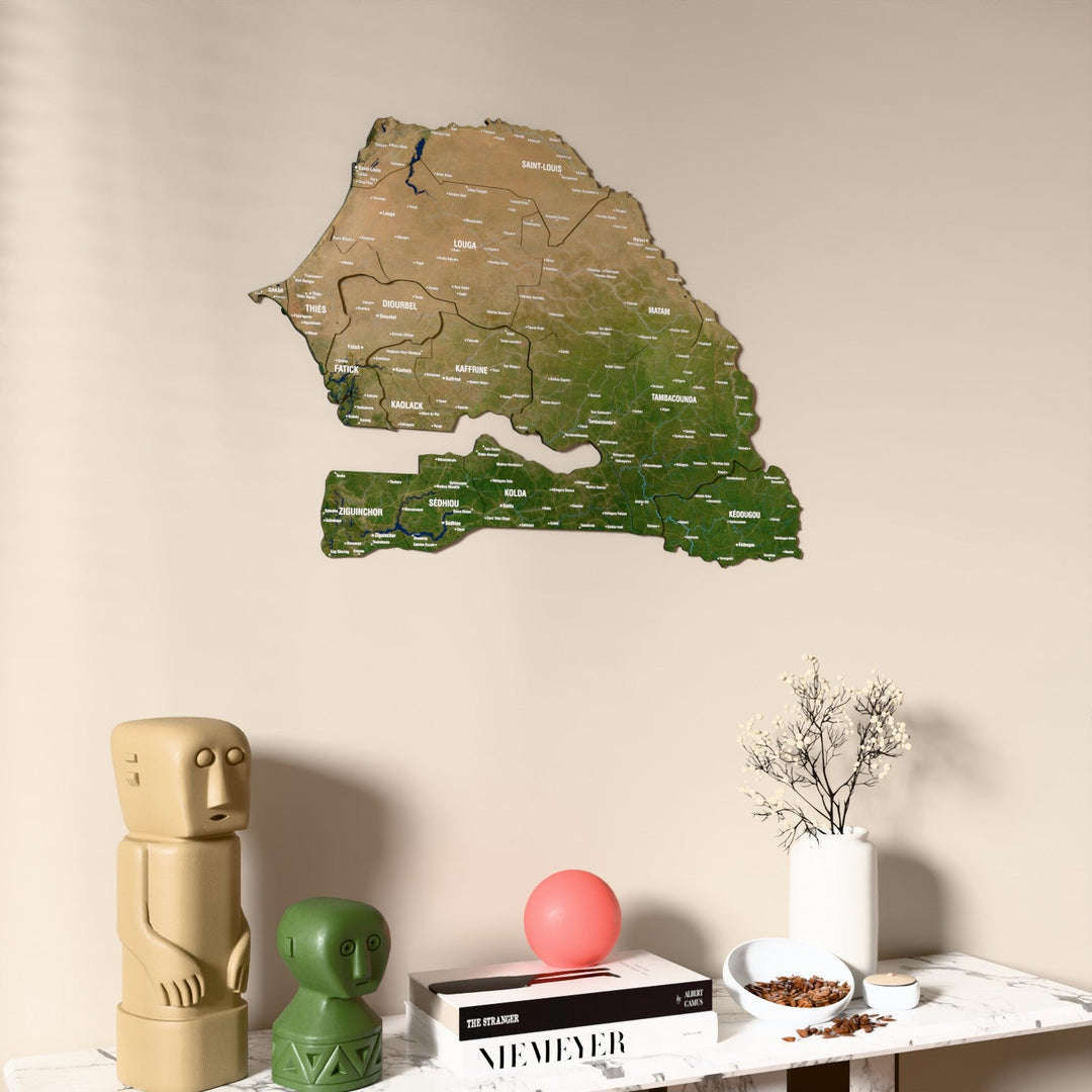 Satellite Senegal wooden wall map on a beige wall above a console with figurines