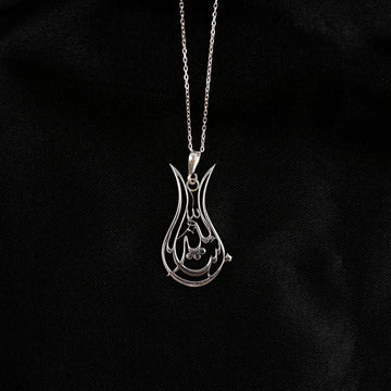 Small view of the Silver Tulip Mashallah necklace on its chain against black