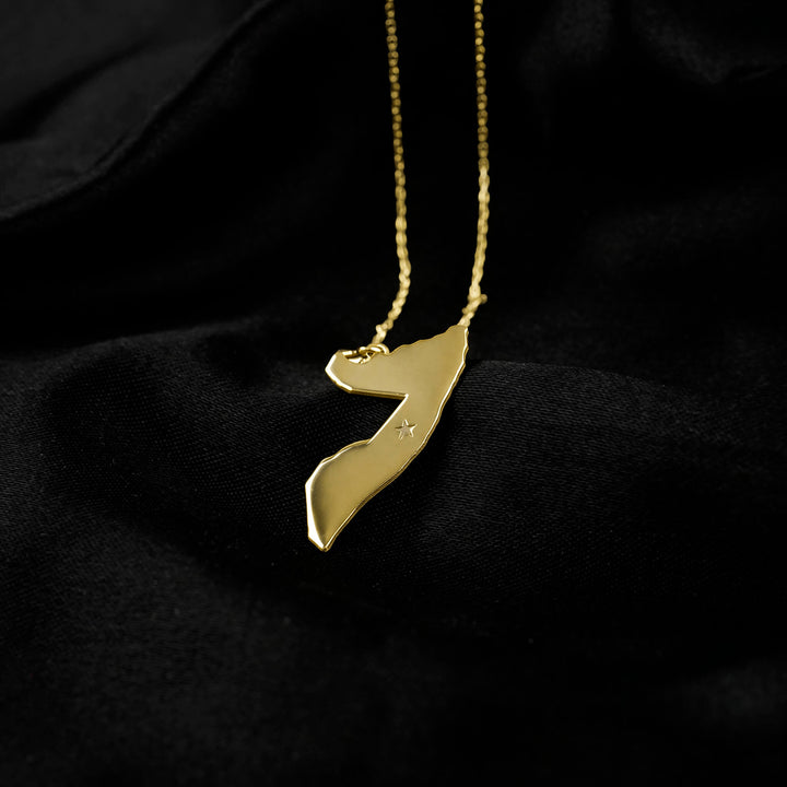 Somalia map necklace in gold on black satin