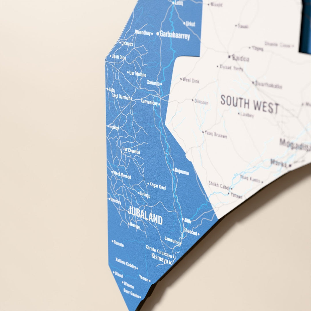 Close-up of the Flag colored Somalia wooden wall map with layered regions and printed names