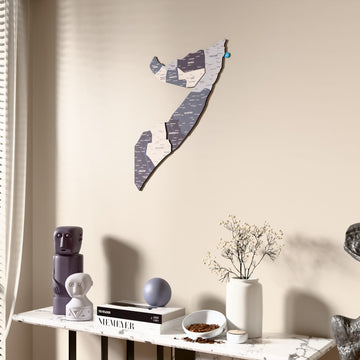 Nimbus Somalia wooden wall map beside a sheer curtain, angled view