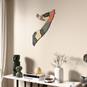 Sage Somalia wooden wall map beside a sheer curtain, angled view