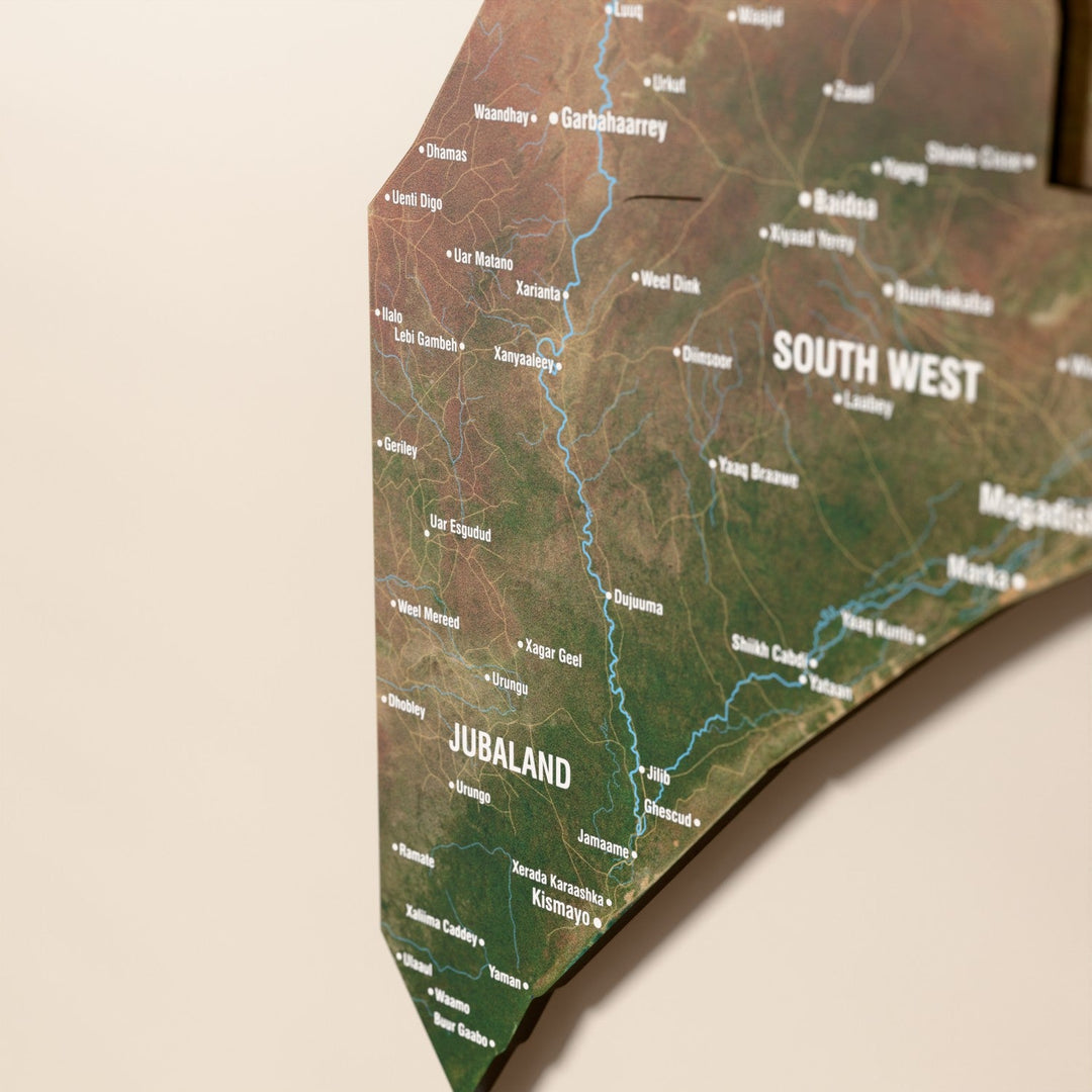 Close-up of the Satellite Somalia wooden wall map with layered regions and printed names