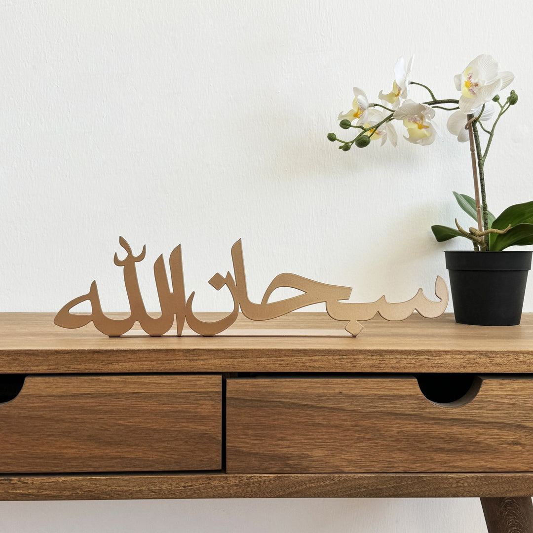 ديكور طاولة معدني نحاسي «سبحان الله» على مكتب خشبي، منظر أمامي مع زهرة أوركيد