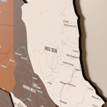 Close-up of the Soil Sudan wooden wall map with layered regions and printed names