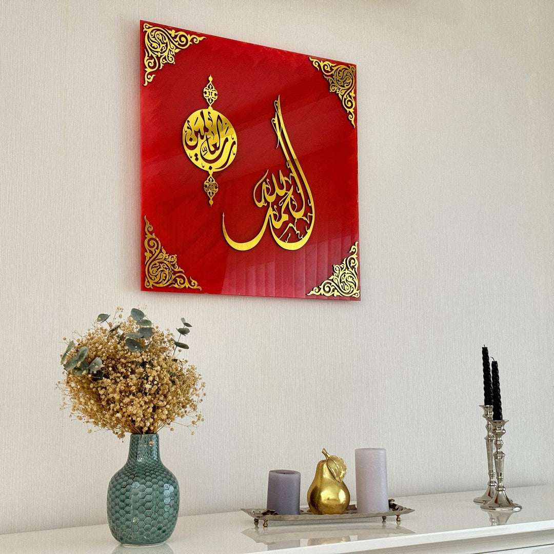 Angled view of Surah Fatiha Ayat 1 red glass wall art with gold calligraphy on a wall