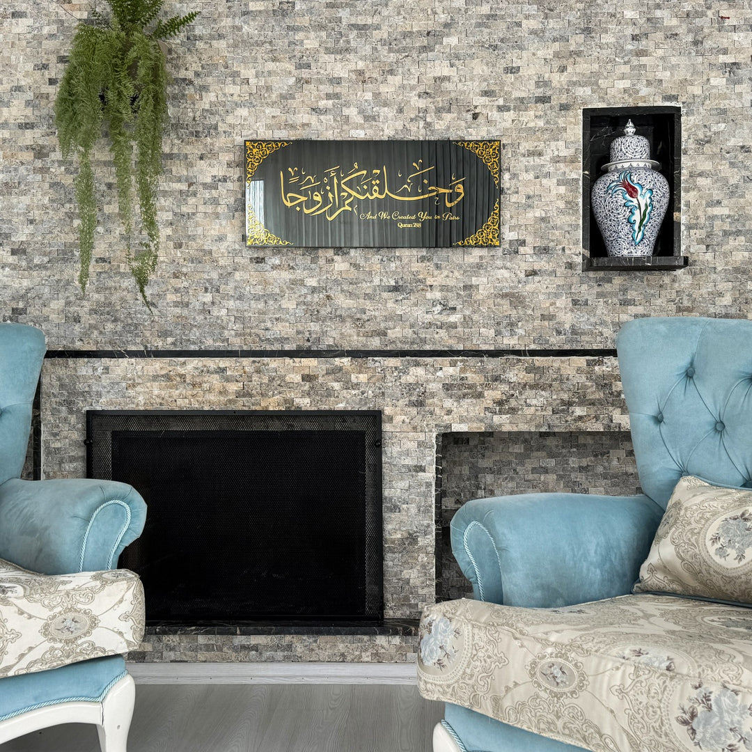 Gold Acrylic on Black Mirror Surah Naba Verse 8 tempered glass wall art above a fireplace between two armchairs