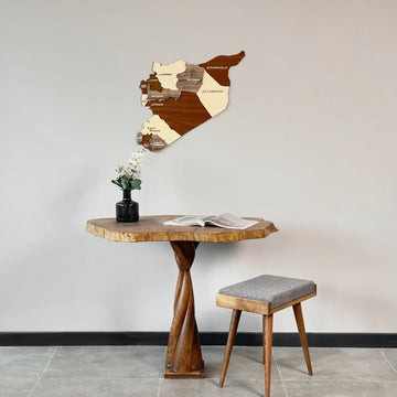 Syria wooden wall map hung above a live-edge wooden table with a vase and stool