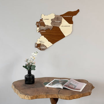 Syria wooden wall map angled view above a round wooden table with a vase and open magazine