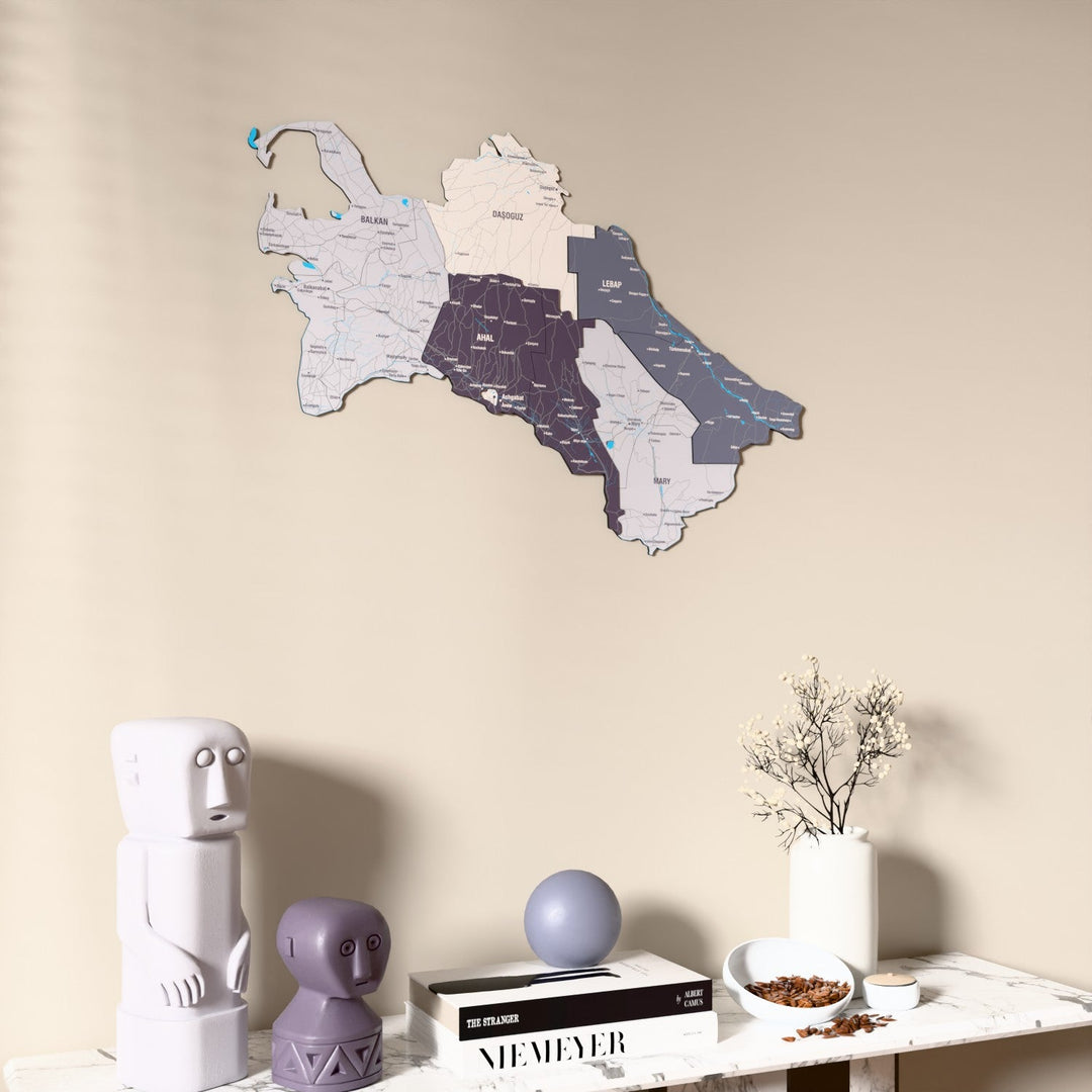 Nimbus Turkmenistan wooden wall map on a beige wall above a console with figurines