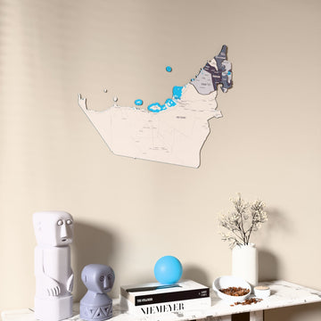 Nimbus United Arab Emirates wooden wall map on a beige wall above a console with figurines