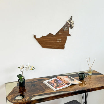 United Arab Emirates wooden wall map above a desk with a reed diffuser, close crop