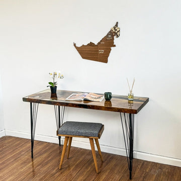United Arab Emirates wooden wall map above a desk and stool, view from a lower angle