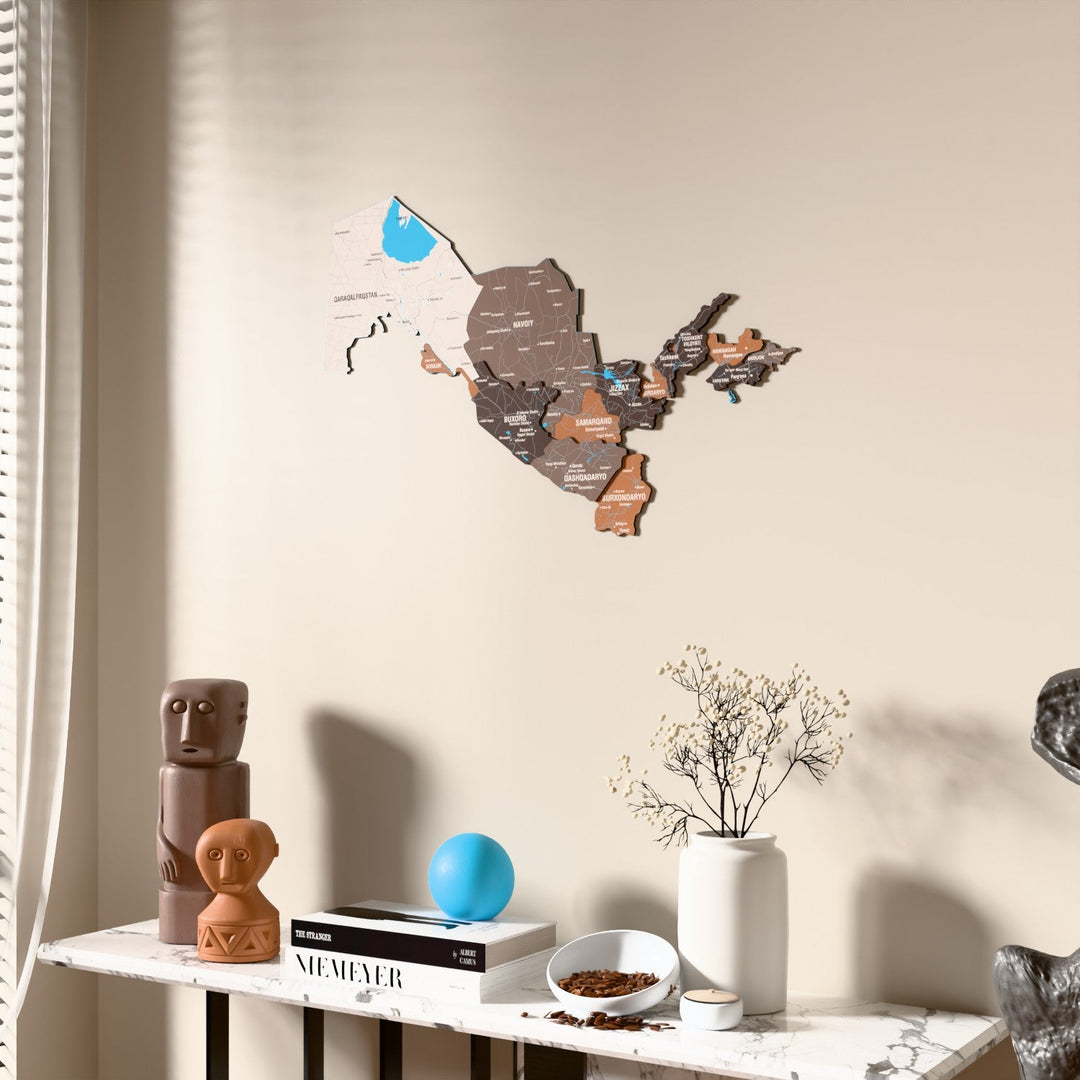 Soil Uzbekistan wooden wall map beside a sheer curtain, angled view
