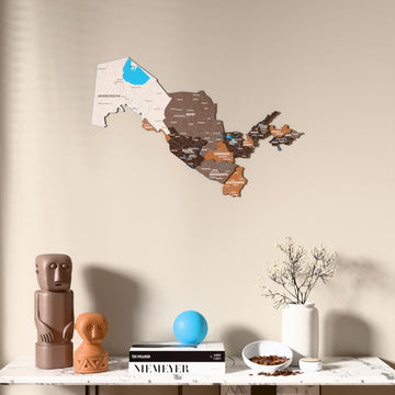Soil Uzbekistan wooden wall map above a marble console, front view