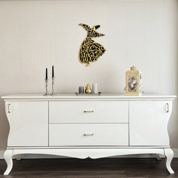 Gold whirling dervish wooden wall art on a wall, wide view of the white sideboard below