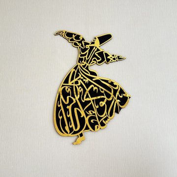 Whirling dervish wooden wall art with a gold acrylic face, front view on a plain wall