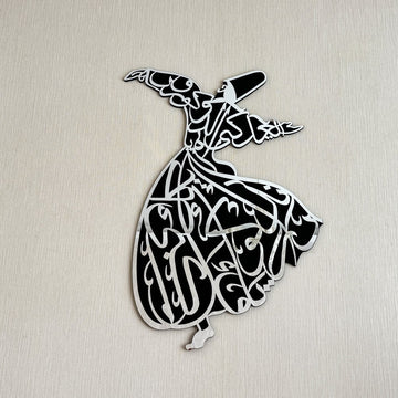 Whirling dervish wooden wall art with a silver acrylic face, close front view on a beige wall