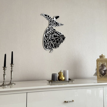 Silver whirling dervish wooden wall art on a wall above a white sideboard with candlesticks