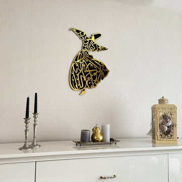 Gold whirling dervish wooden wall art on a wall above a white sideboard, closer view