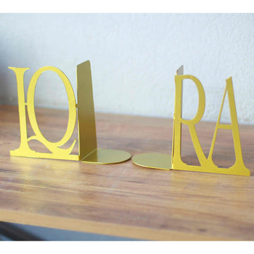 Pair of gold IQRA Latin letter bookends standing apart to show the L-shaped bases