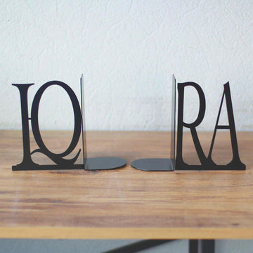 Pair of black IQRA Latin letter bookends standing apart to show the L-shaped bases