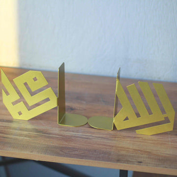 Goldene kufische Buchstützen Allah und Mohammed getrennt auf einem Holztisch, mit sichtbaren runden Fußplatten