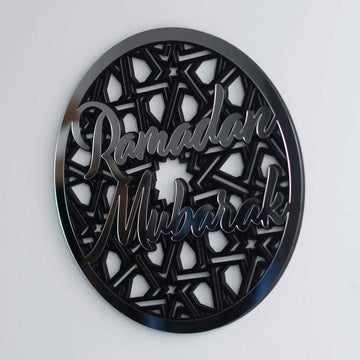 Silver Ramadan Mubarak circular wall decor with star pattern, front view on a pale wall