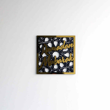 Small gold Ramadan Mubarak square wall art on a white wall, wide view